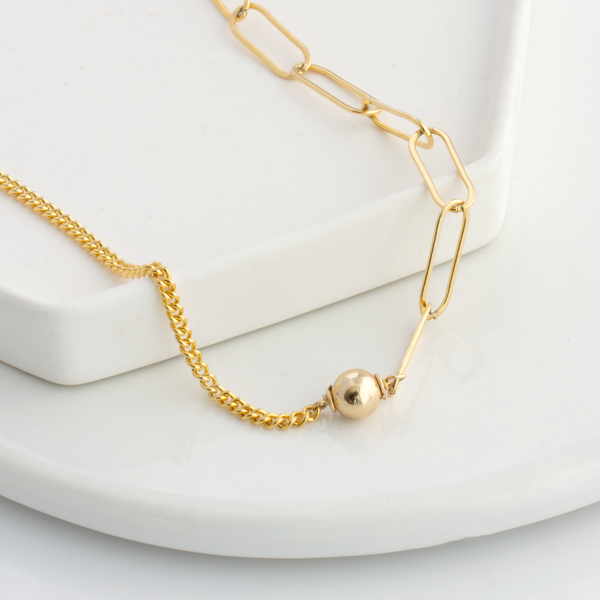 A small ball that sales can go on a necklace