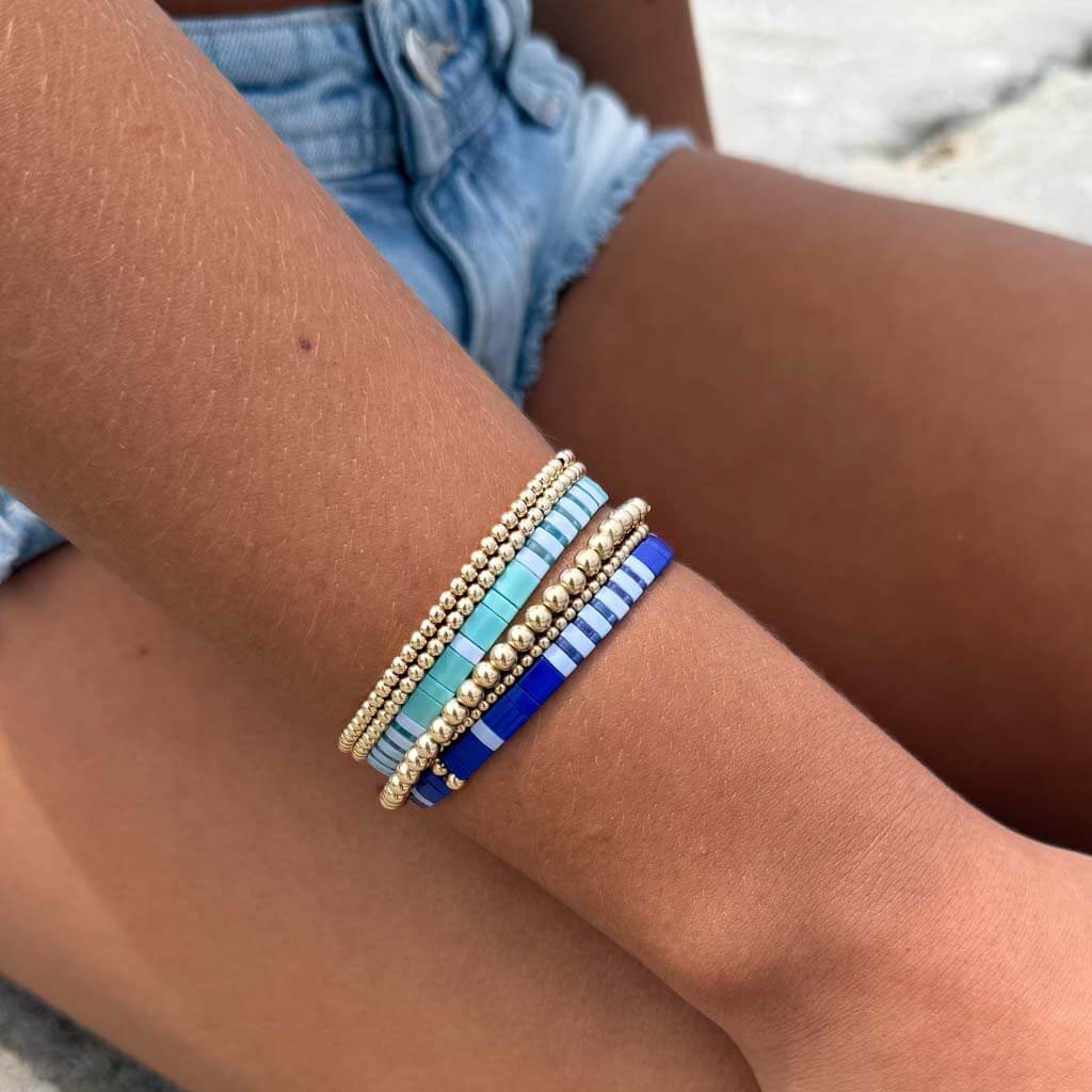 Mosaic Pattern Tila bracelet worn on the wrist with a colorful stacked bracelet look.